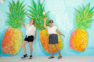 Kim and Tamara in front of pineapple mural