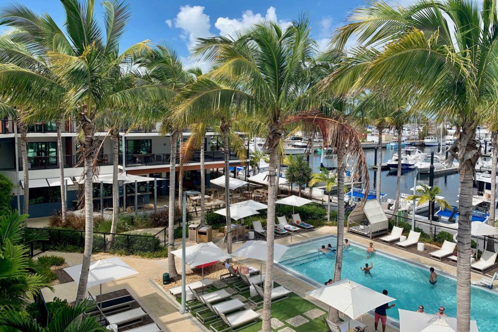 View of the pool and palm trees looking down from the balcony at the Perry Hotel Key West