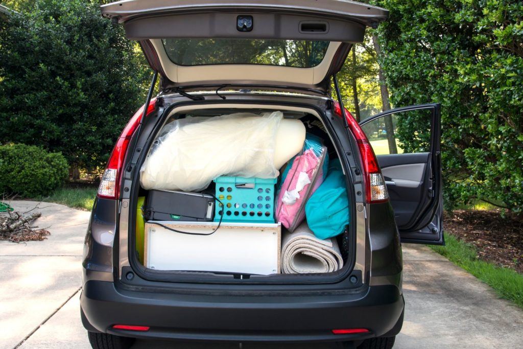 car packed with college dorm stuff with back hatch open