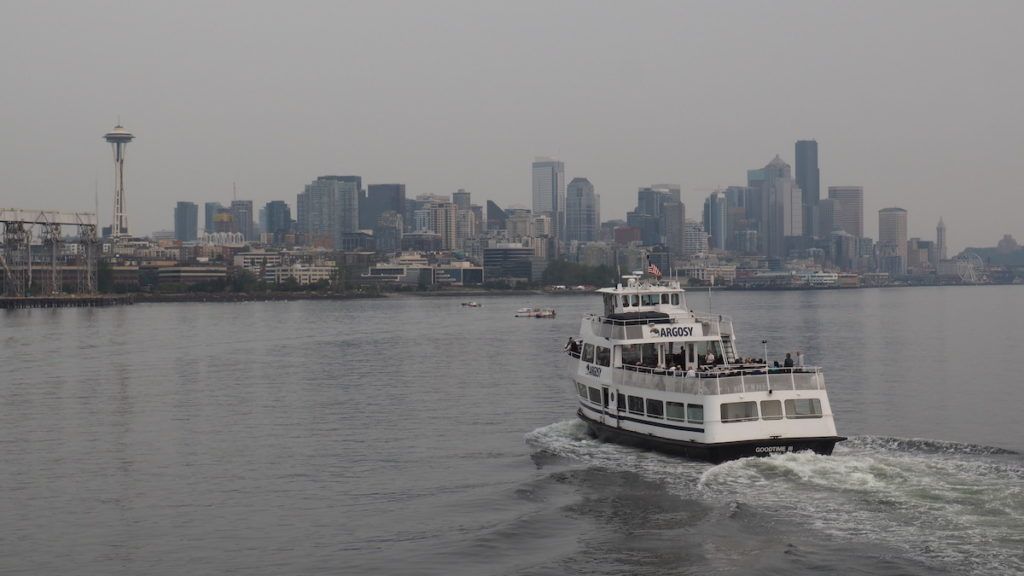 Seattle ferry on water with skyline and Space Needle in the background