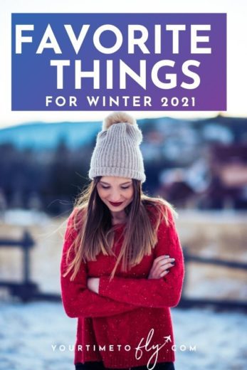 Favorite things for winter 2021 with girl in red sweater and tan hat standing in snow and looking down