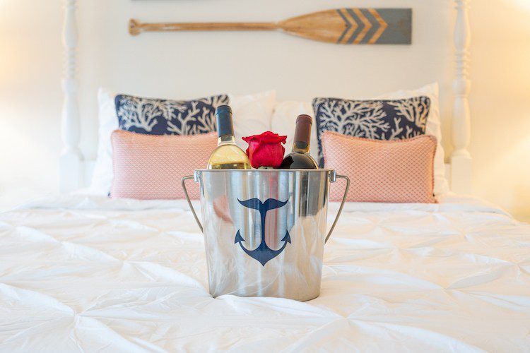 Wine bucket on bed with a rose at the Whaler's Inn
