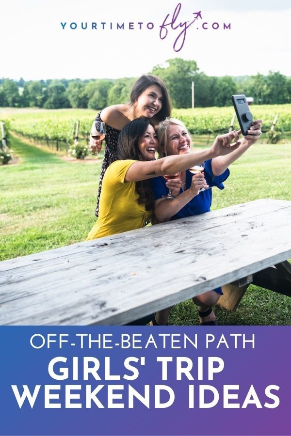 Off the beaten path girls's trip weekend ideas with three women in a vineyard taking a selfie