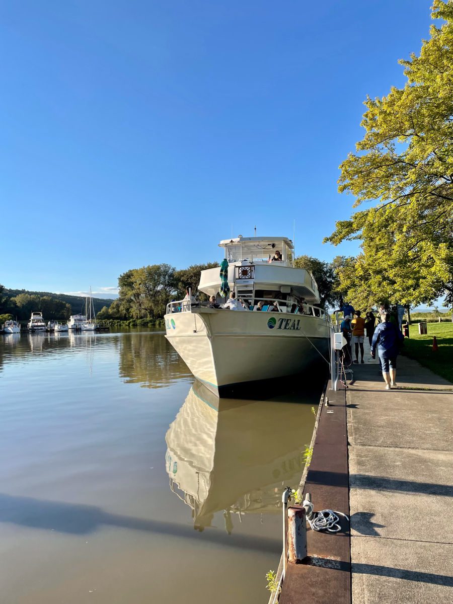 Discover Cayuga Lake boat tours Teal boat at dock in Ithaca