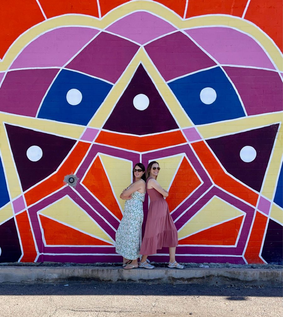 Kim and Tamara back to back in front of the Dhaba mural in Tempe AZ