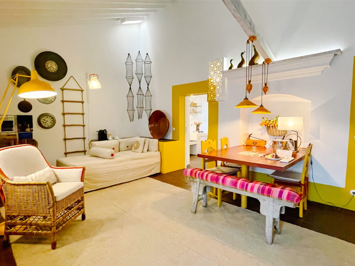 Junior suite at the Torre de Palma hotel with white walls and yellow accents