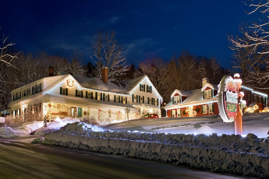 Christmas Farm inn exterior in the snow at night