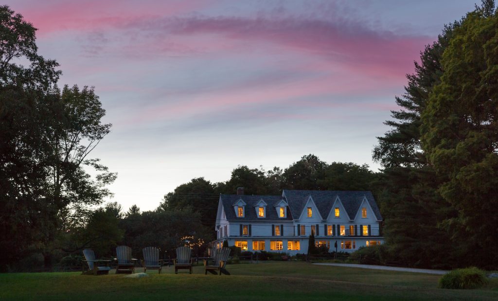 Inn at Pleasant Lake at sunset with lights on