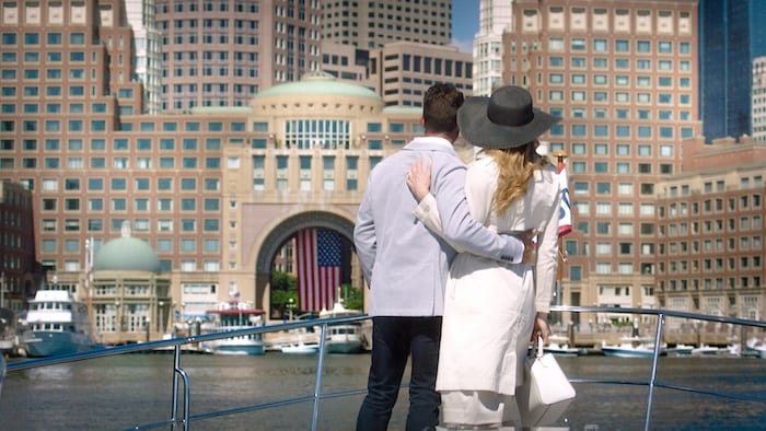 couple standing on boat looking out at the Boston Harbor Hotel