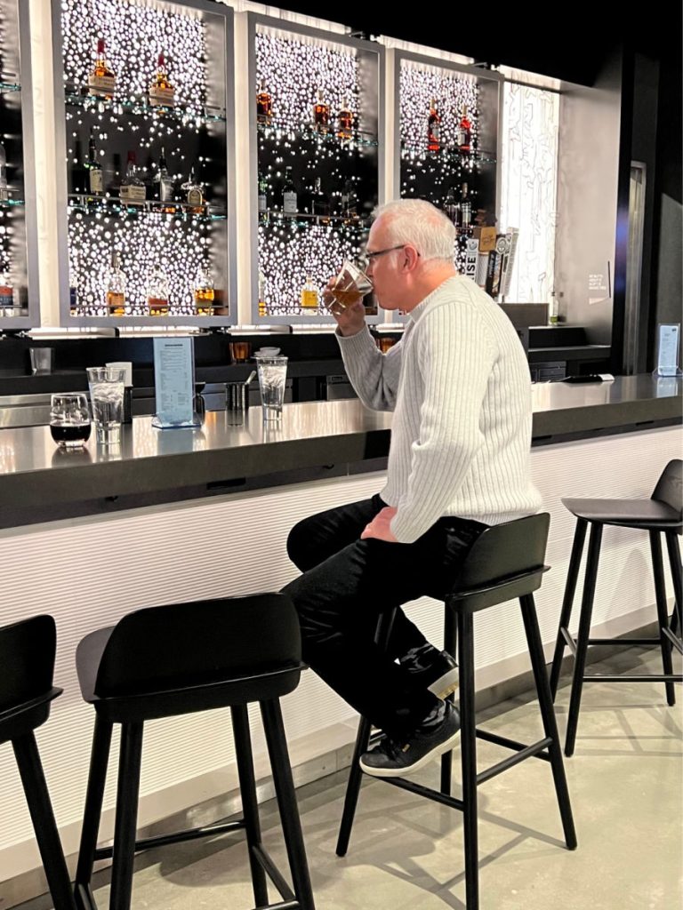 Man drinking at the Aloft Providence lobby bar