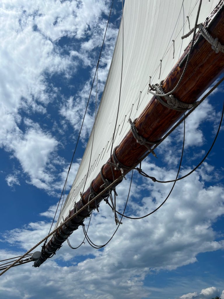 Looking up at the sail and the blue sky