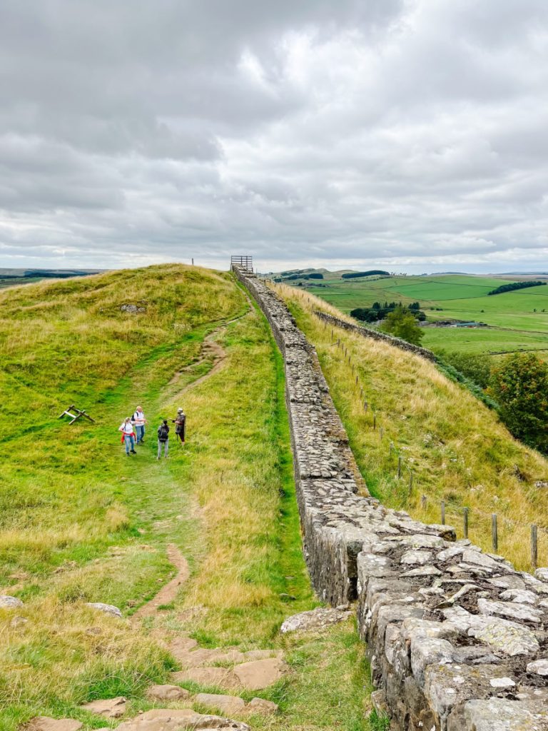 People standing alongside Hadrian's Wall