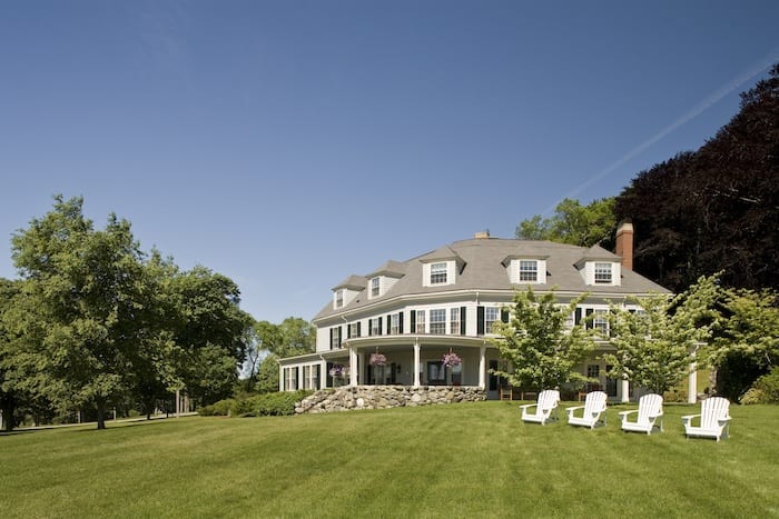 Inn at Castle Hill on the Crane Estate exterior in summer with adirondack chairs out front