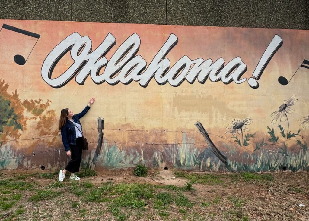 Tamara in front of Oklahoma mural in OKC