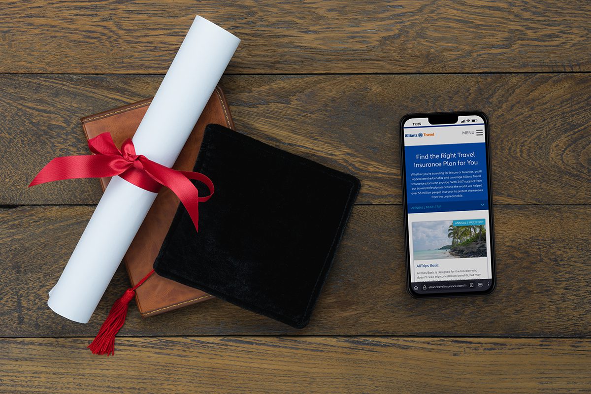 Allianz Travel insurance screenshot on phone next to graduation cap and rolled up diploma with red bow