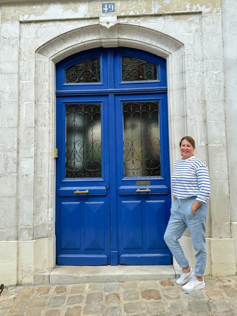 Tamara next to blue doors