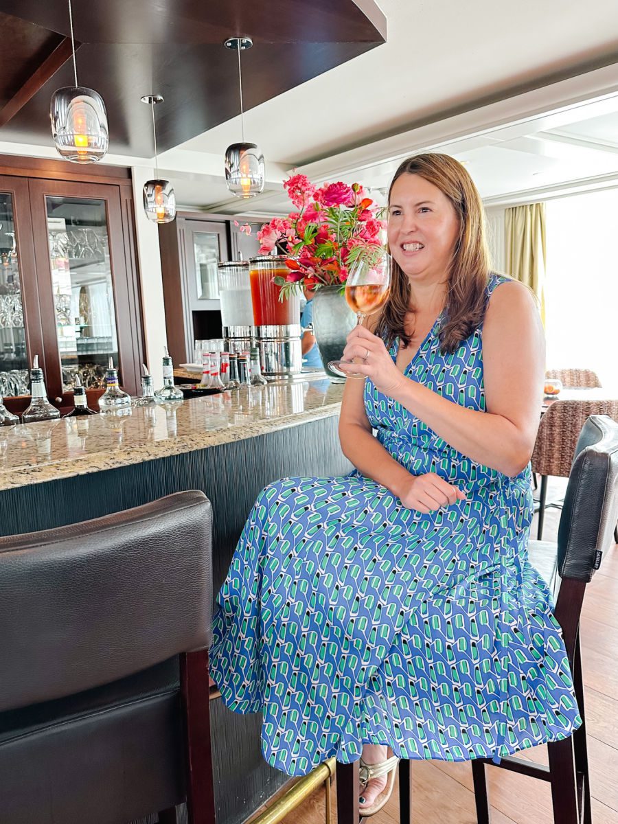 Tamara with glass of rose at bar on AmaDolce