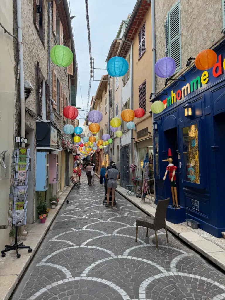 Narrow street with lanterns in Old Town Antibes