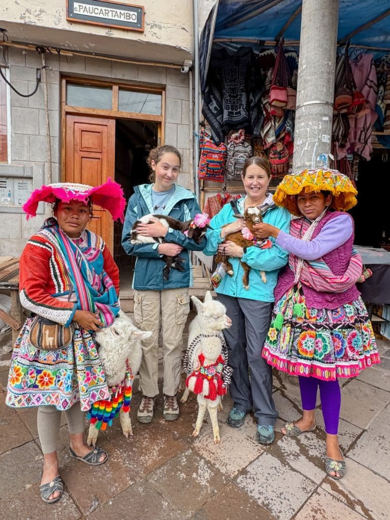 Tamara and Hannah with Peruvian girls and baby alpacas