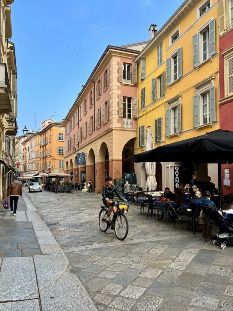 Woman biking on street in Parma