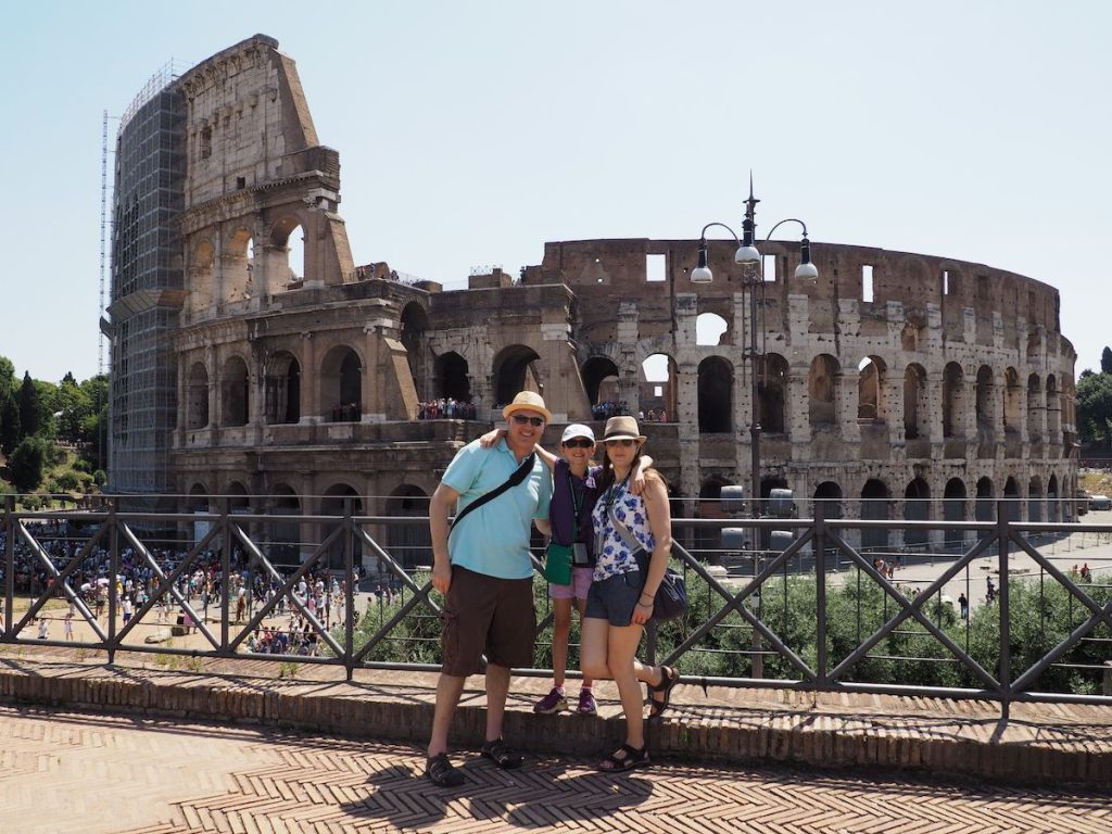 Family posing in front of the Colosseum in Rome