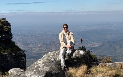 Tamara sitting on rock on cliff in South Africa - South Africa safari packing list